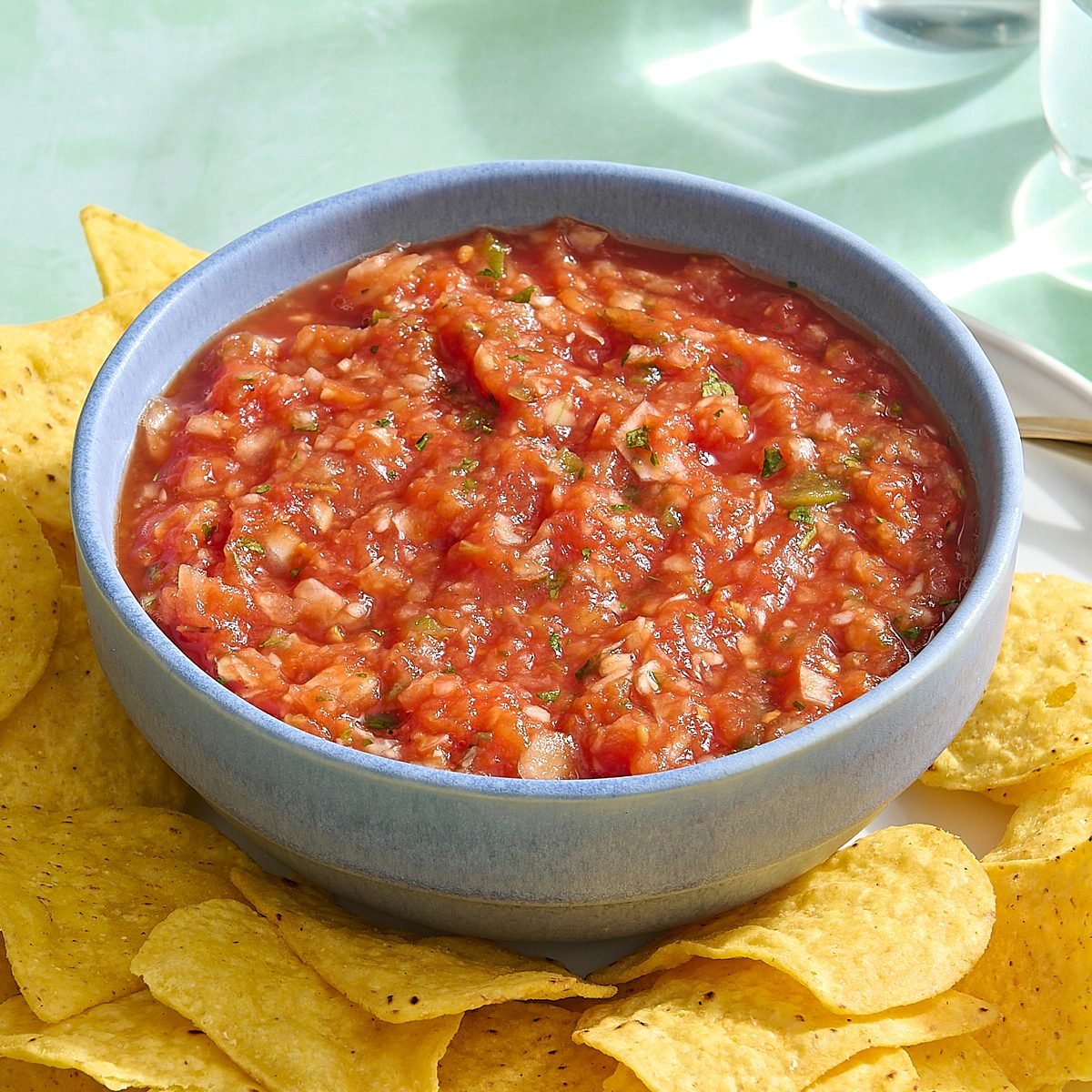 Homemade Mexican salsa in bowl with tortilla chips