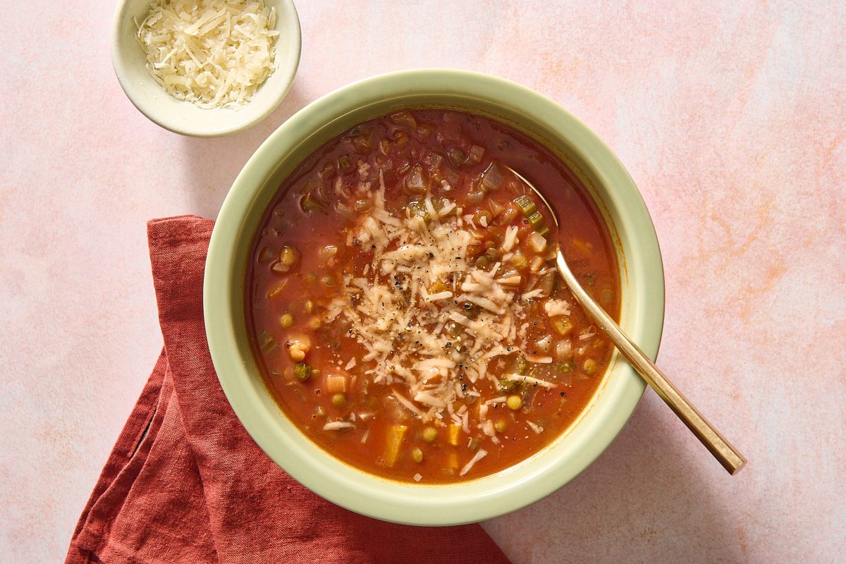 Overhead shot of Italian lentil soup in a bowl with a spoon