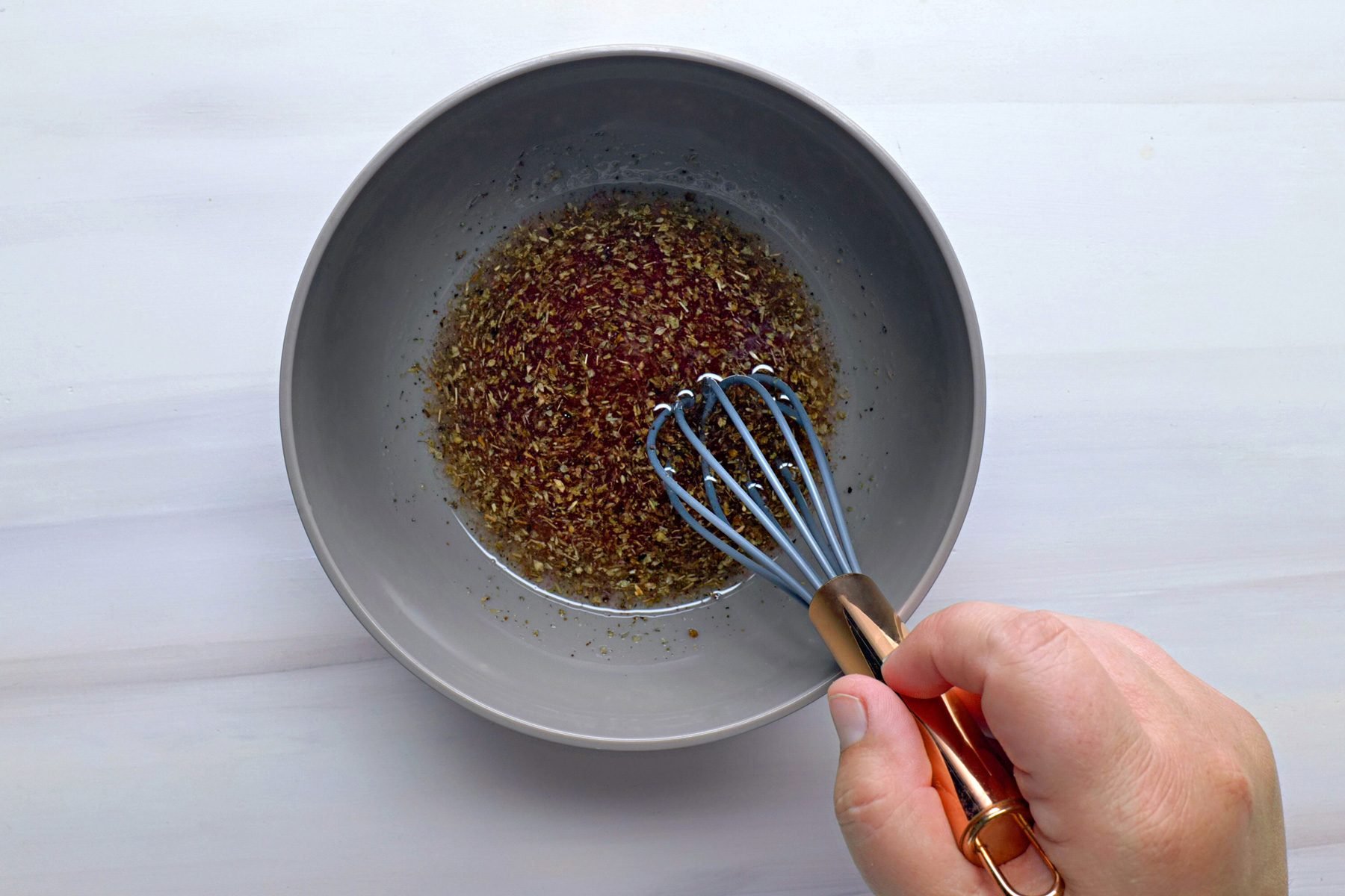 Italian Pasta Salad dressing is being mixed in a bowl