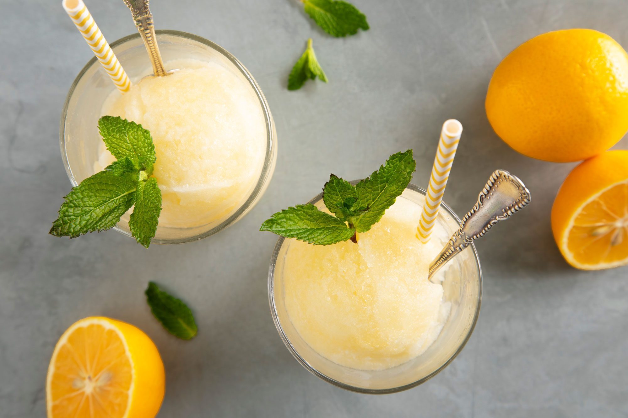 Two glasses of Lemon Ice with mint leaves and oranges