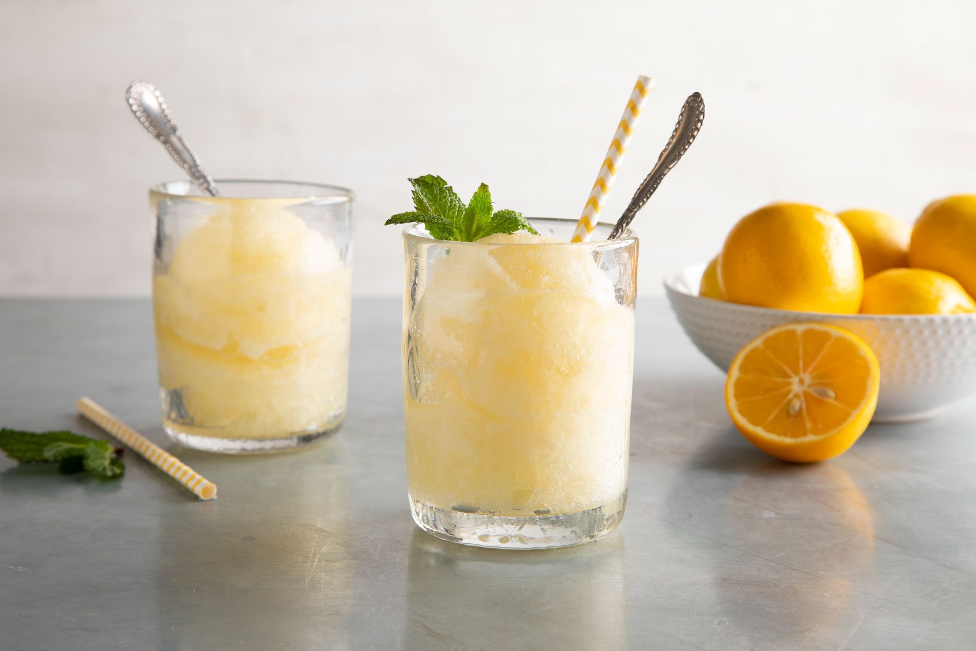 Lemon Ice served in two glasses with mint leaves and oranges