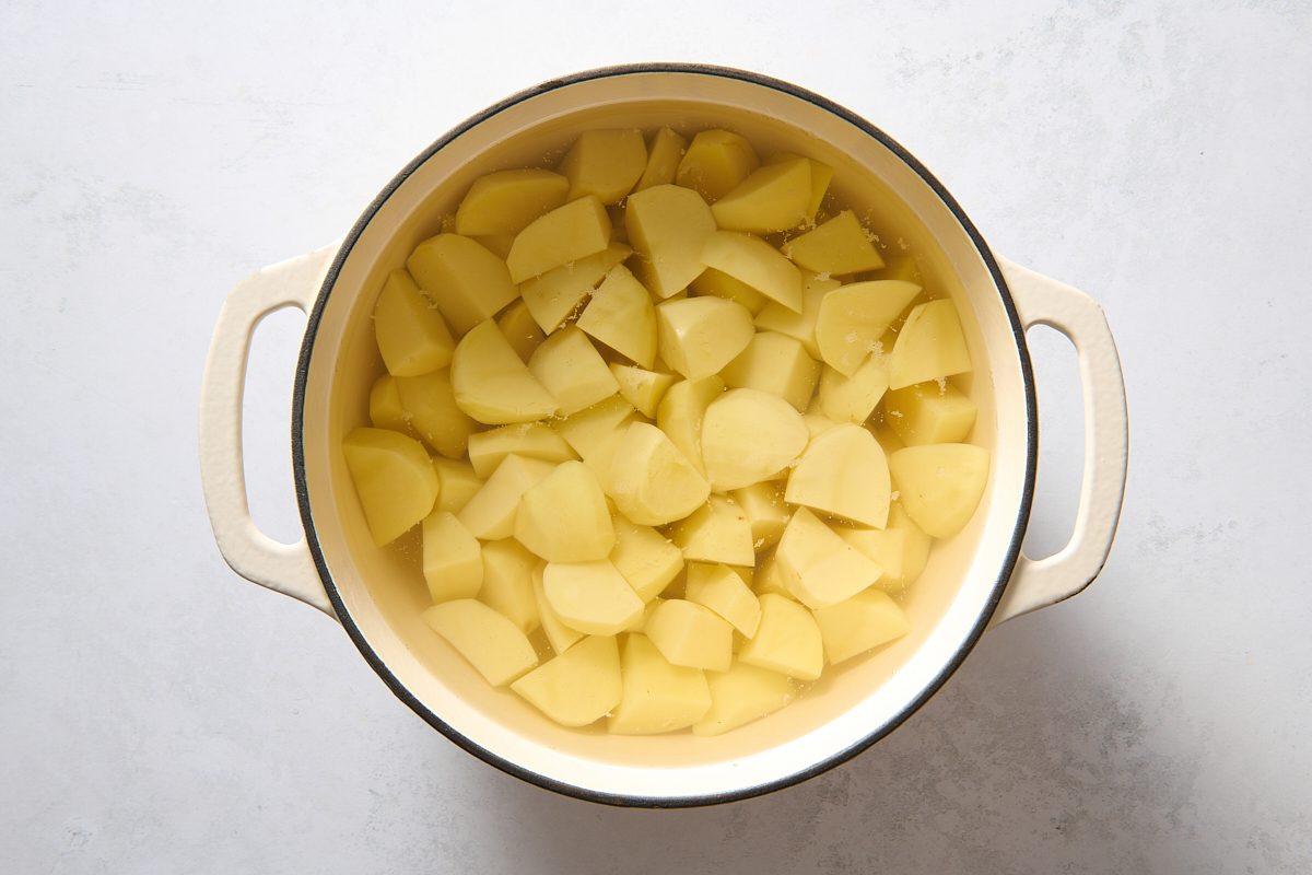 Potatoes covered in water in a Dutch oven