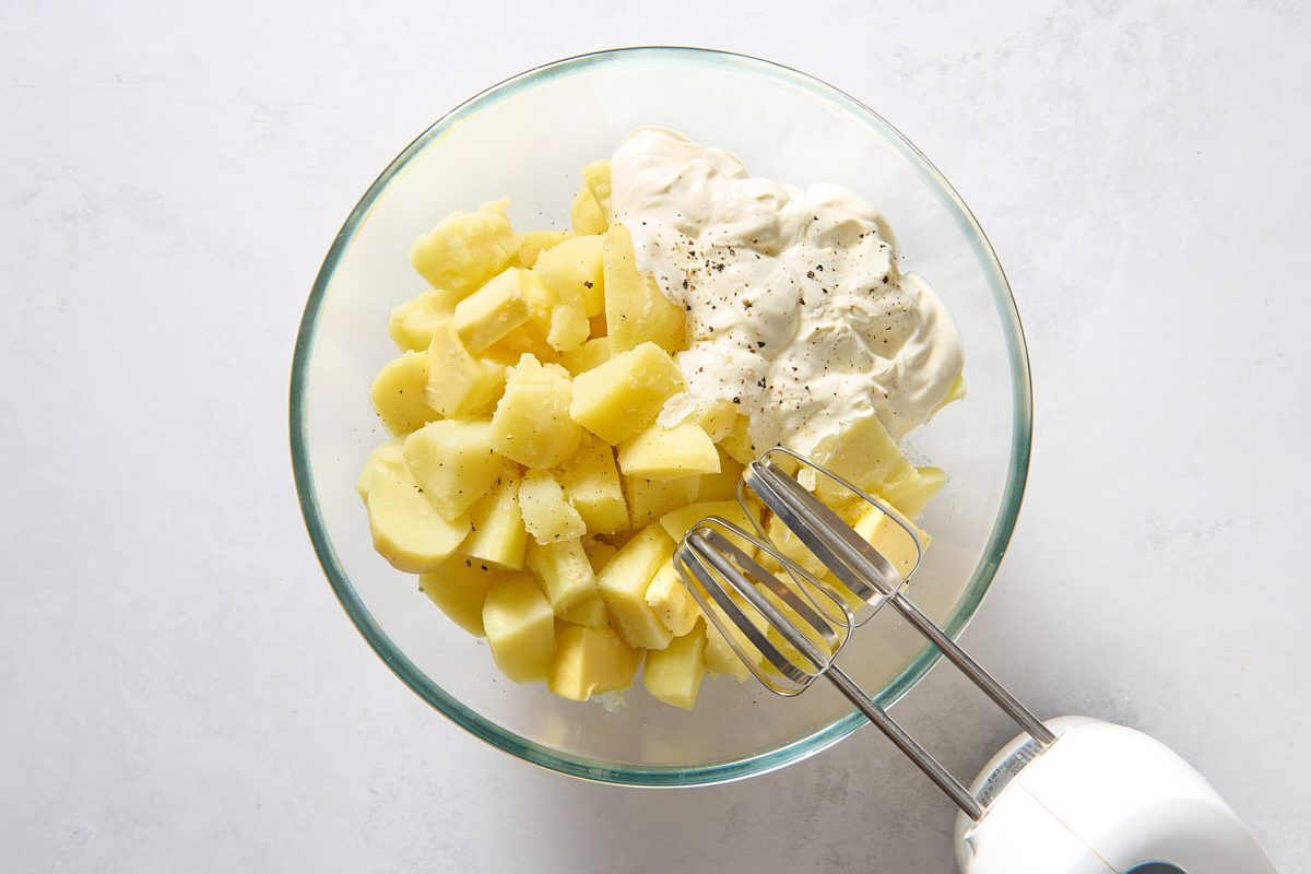 Mashing the potatoes with a mixer