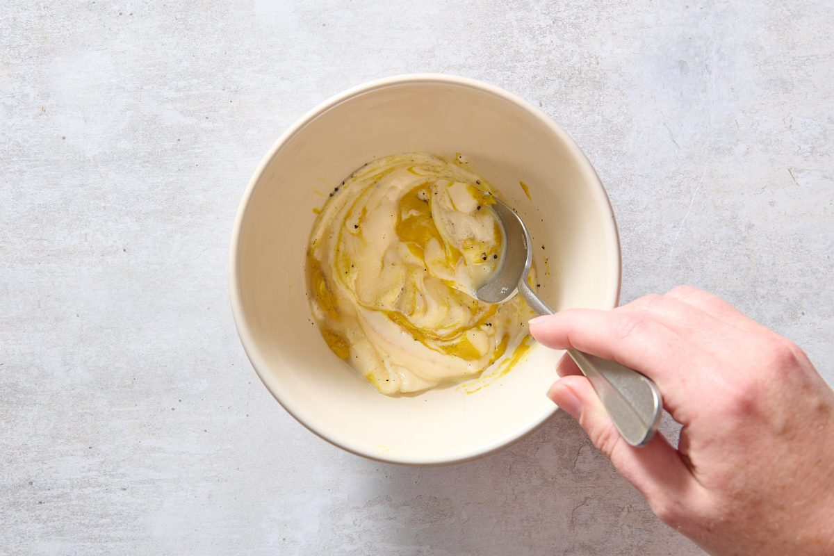 Mixing the dressing in a bowl