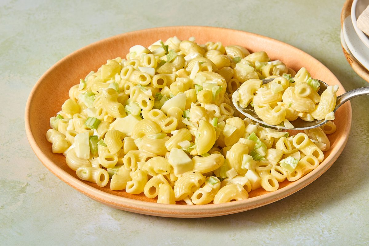 Closeup of macaroni egg salad on a spoon