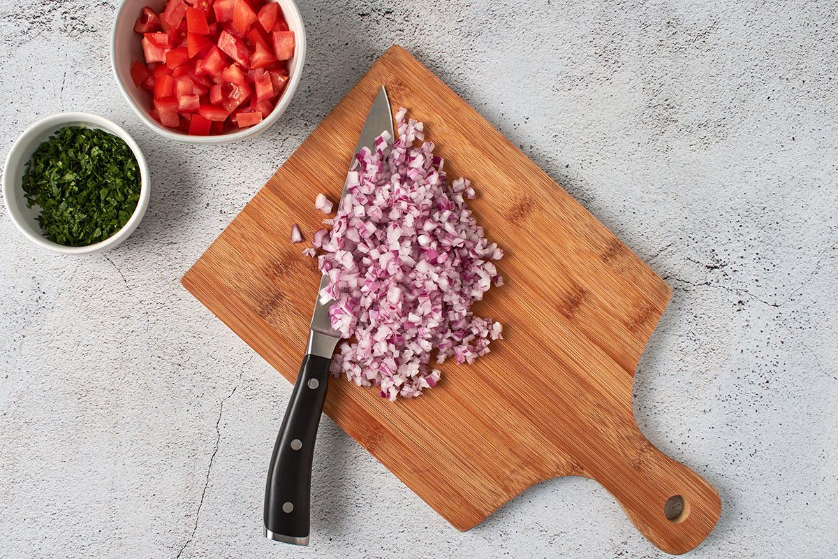 Chop tomato, onion, and cilantro.