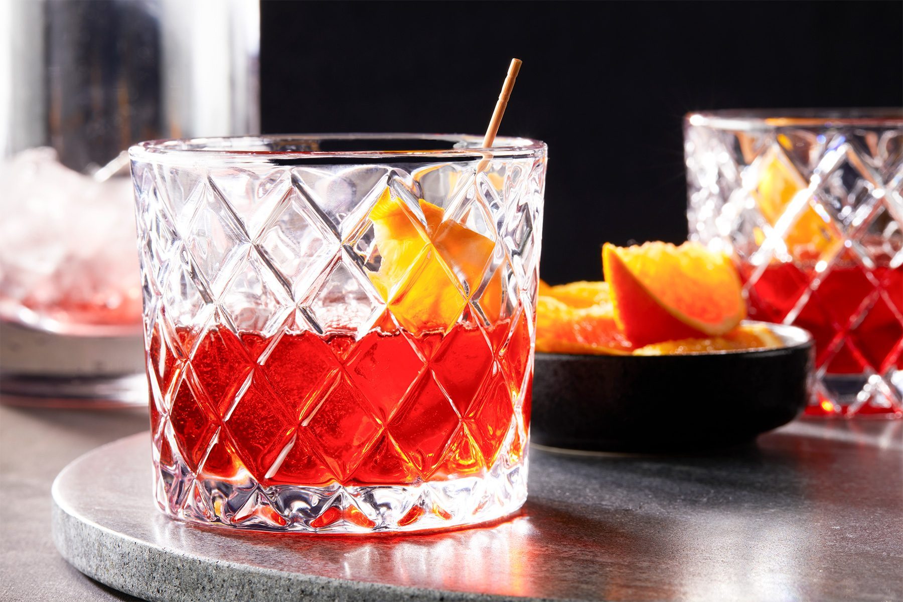 wide shot of Negroni Sbagliato garnished with orange slice; rock glass