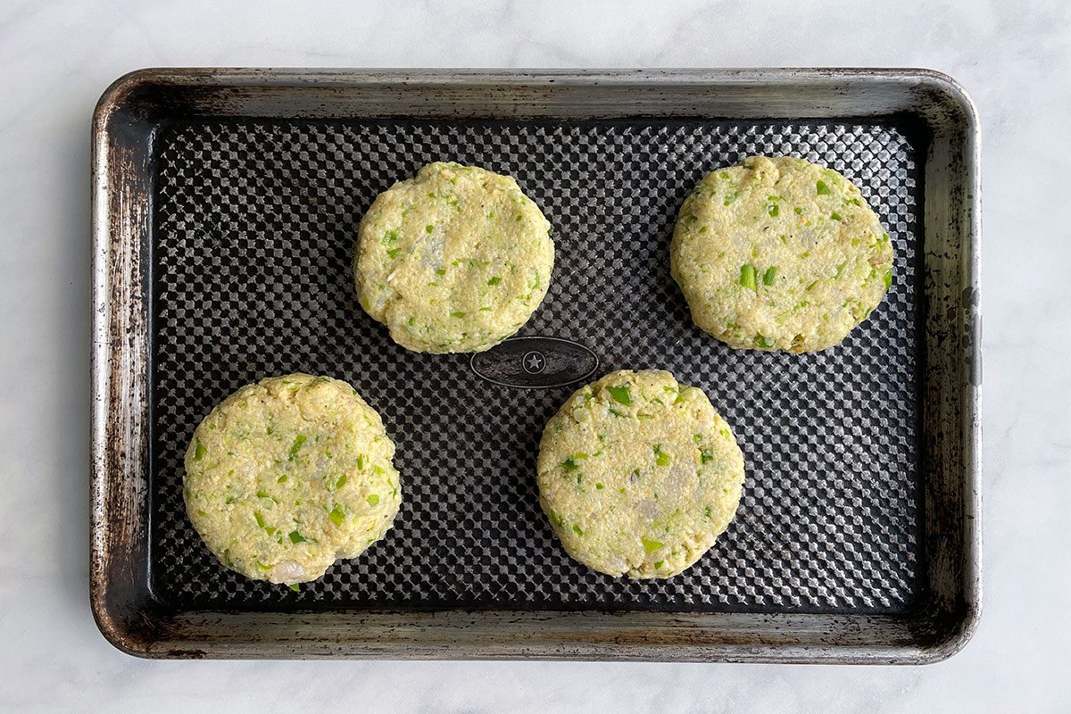 Forming patties on a metal tray for Taste of Home's shrimp burgers recipe.