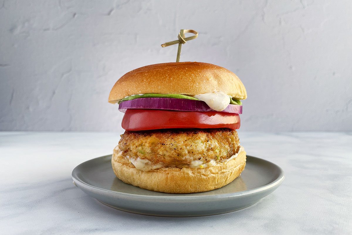 Taste of Home's shrimp burger with buns, lettuce, onion, and tomato.