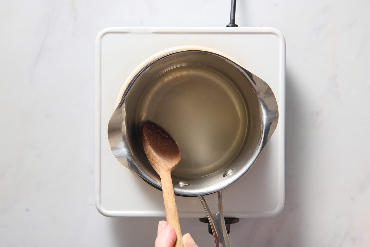 Stirring syrup ingredients in a saucepan