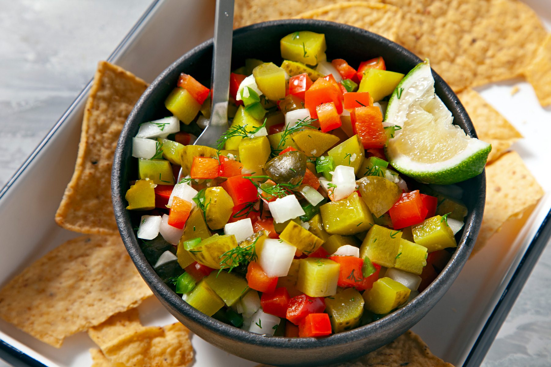 Pickle De Gallo in a bowl with chips on the side