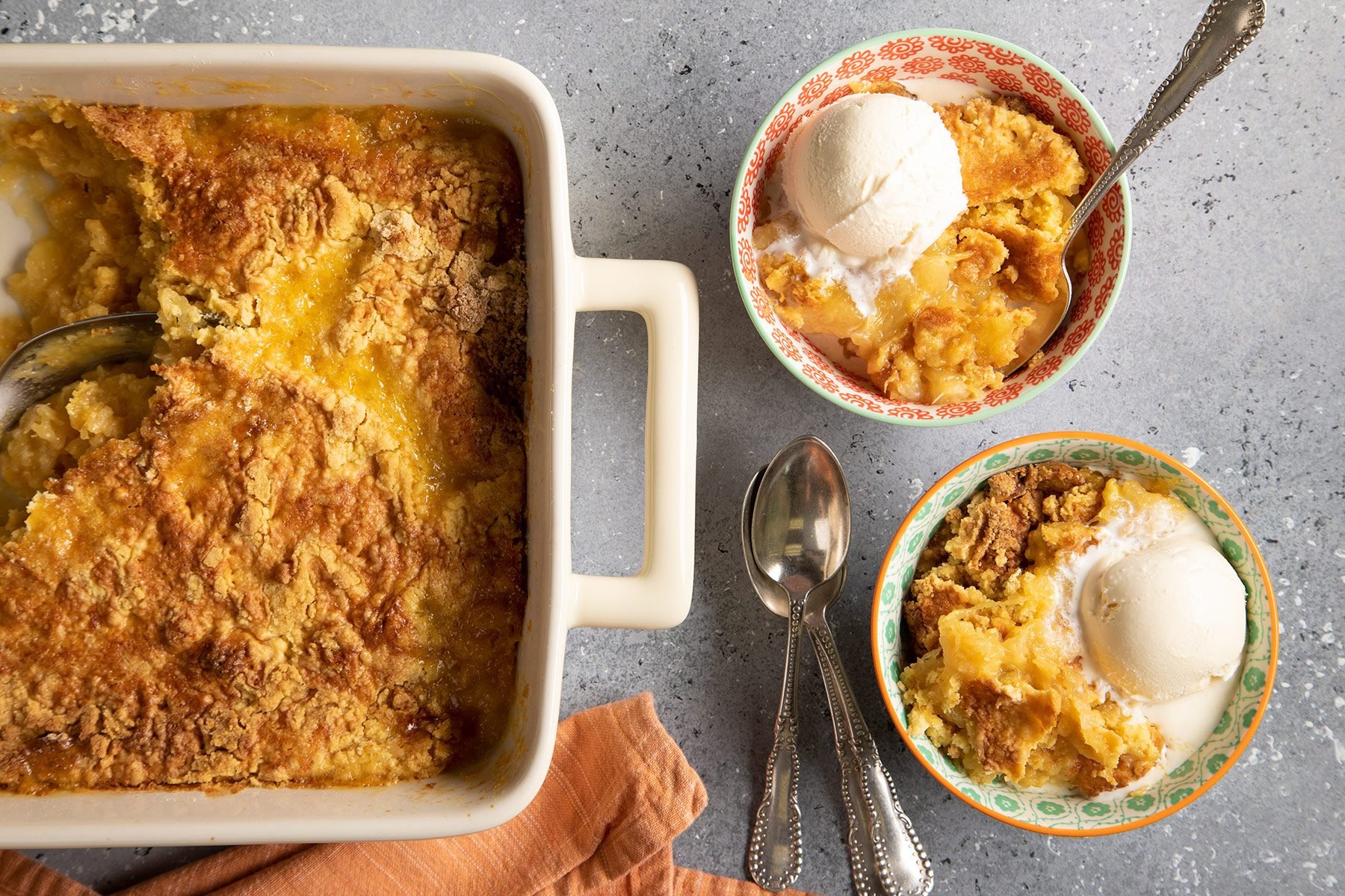 Pineapple Dump Cake served with ice cream in bowls