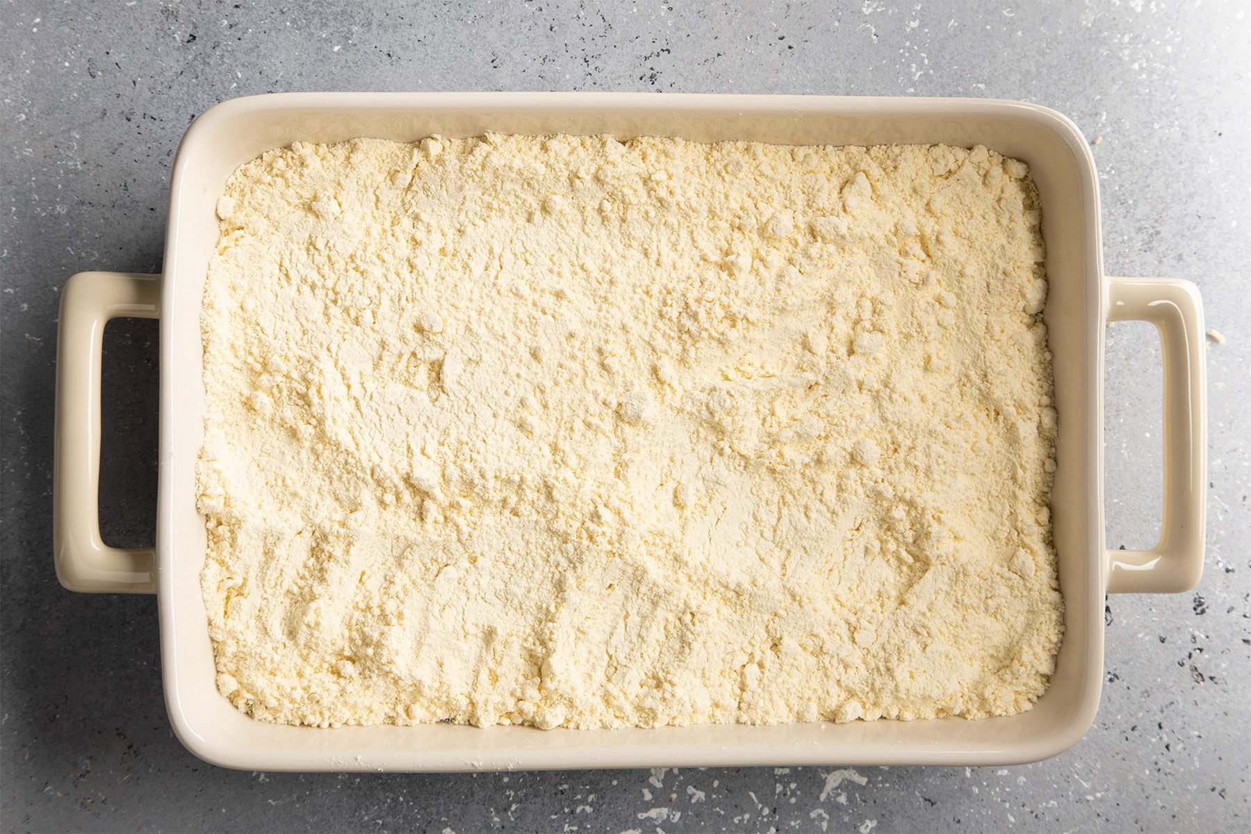 Cake mix over pineapples in baking dish