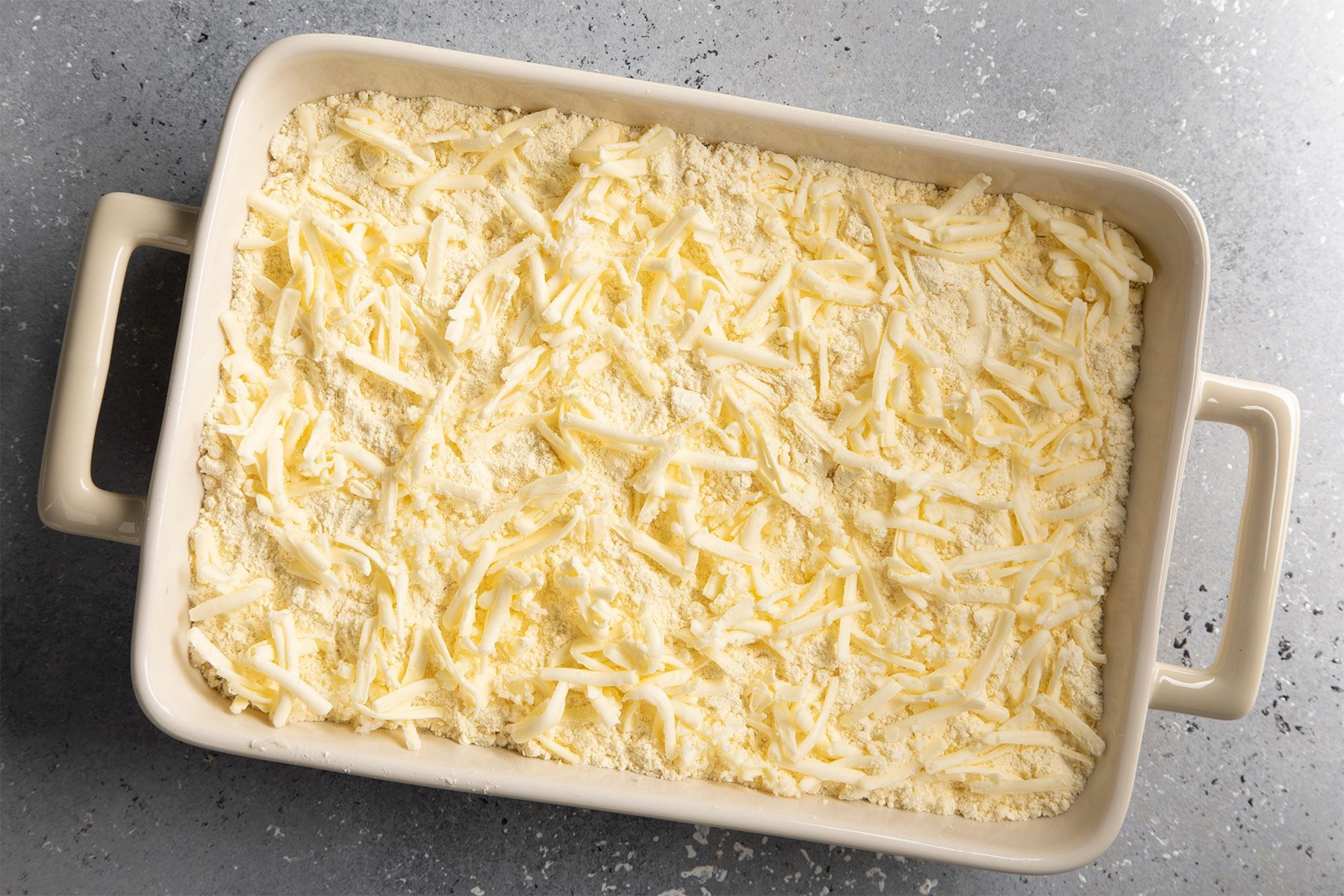 Shredded Butter over cake mix in baking dish