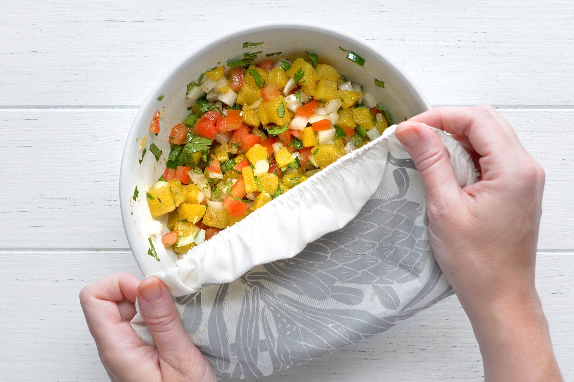 overhead shot; white background; covering the bowl with cloth;