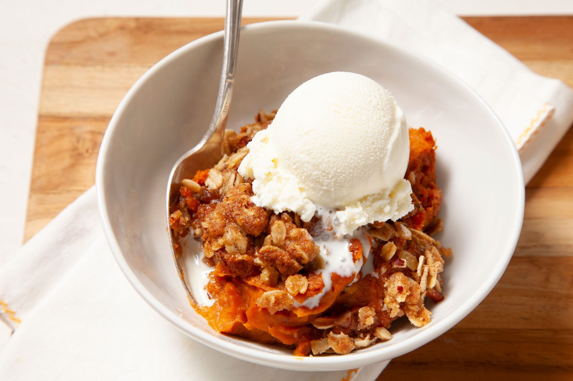 Pumpkin Crisp served in a bowl with ice cream
