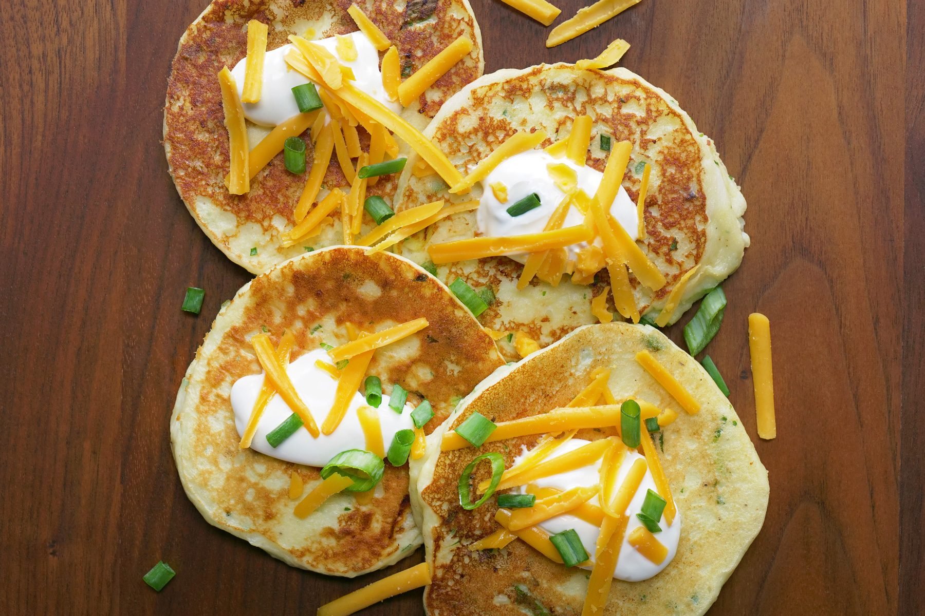 Top view of mashed potato pancakes with different toppings