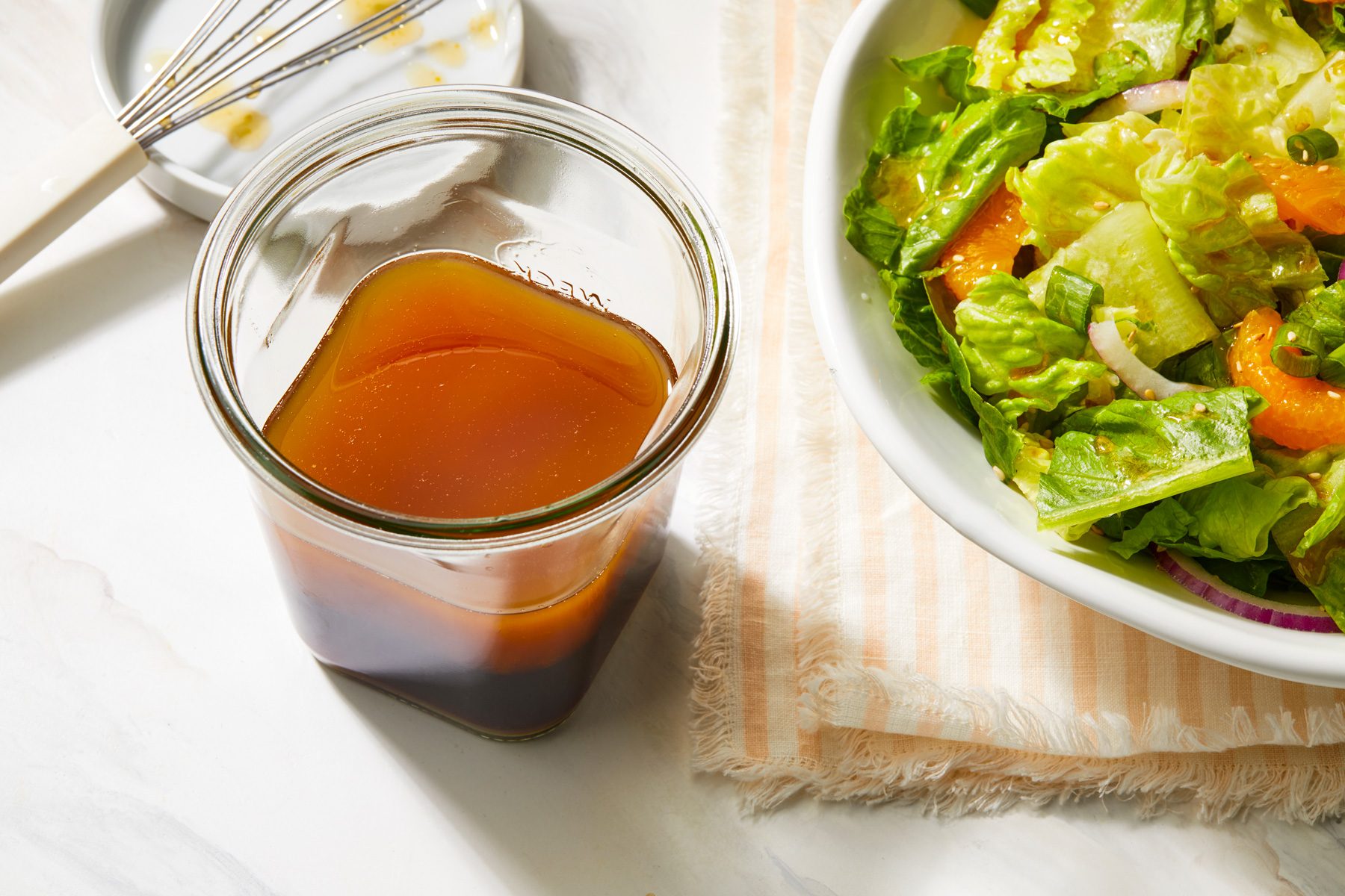 Sesame salad dressing jar with salad plate