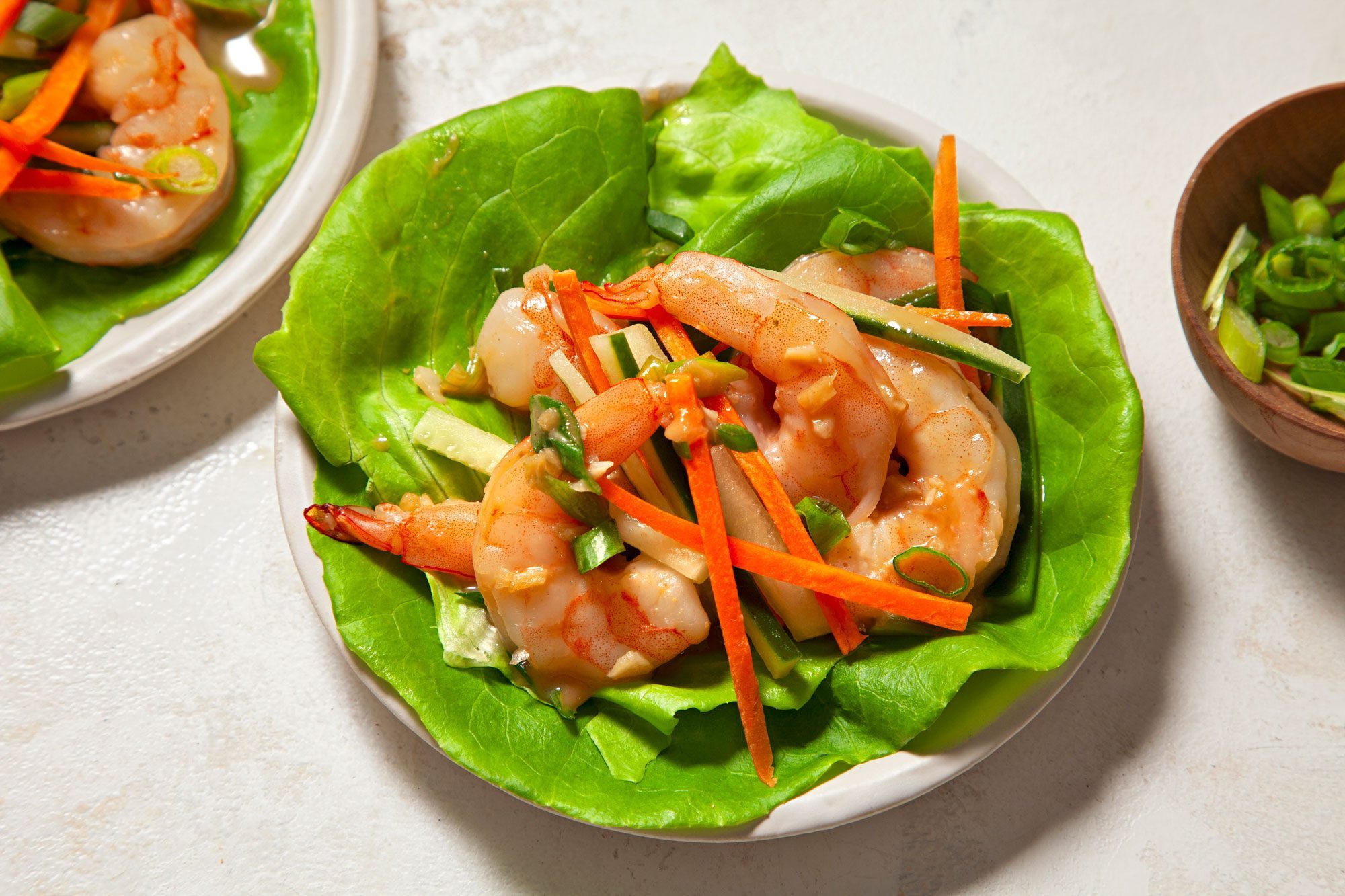 Shrimp Lettuce Wraps topped with the chopped carrots and cucumber