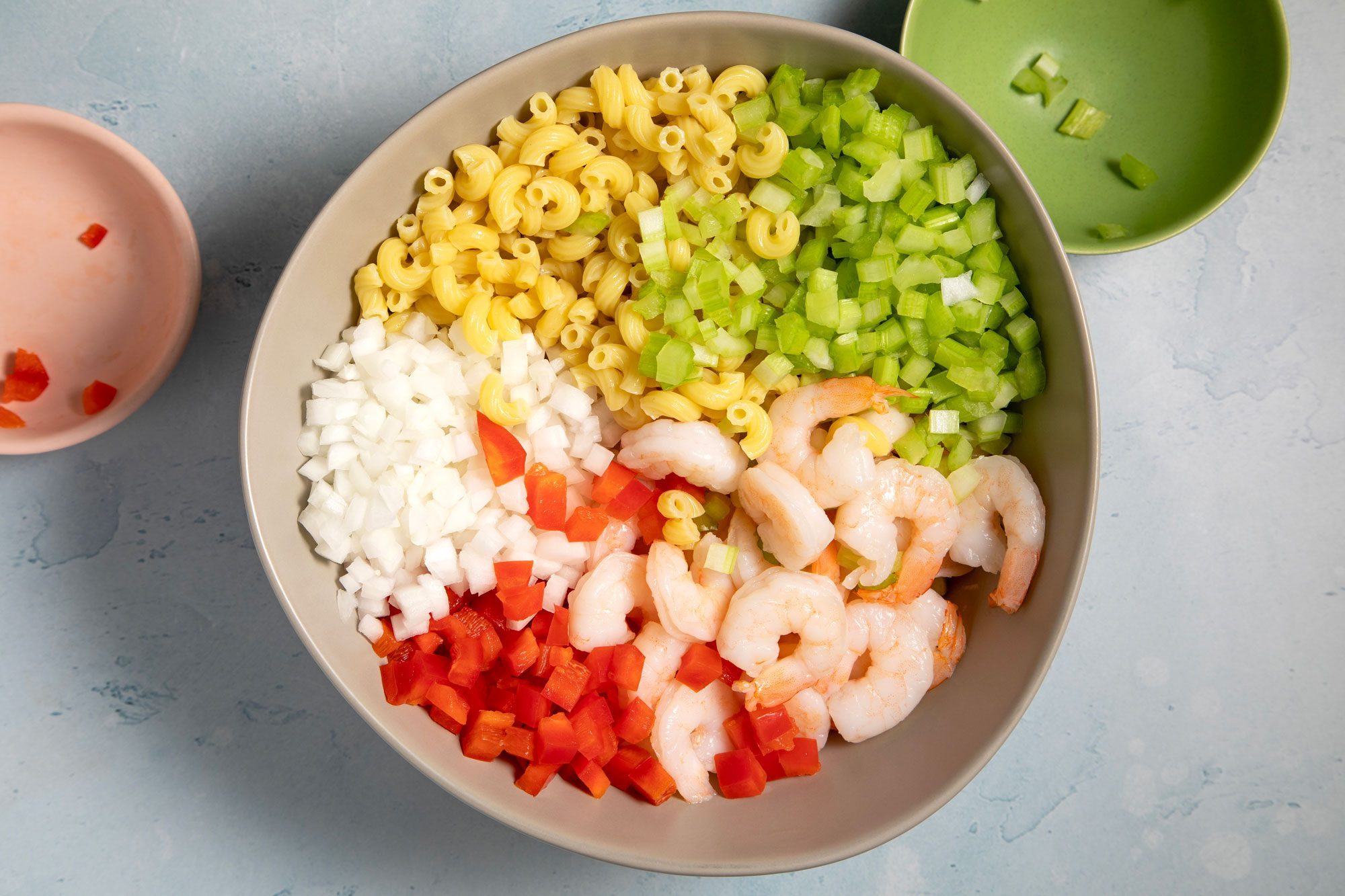 In a large bowl, combine the pasta, shrimp, celery, pepper and onion