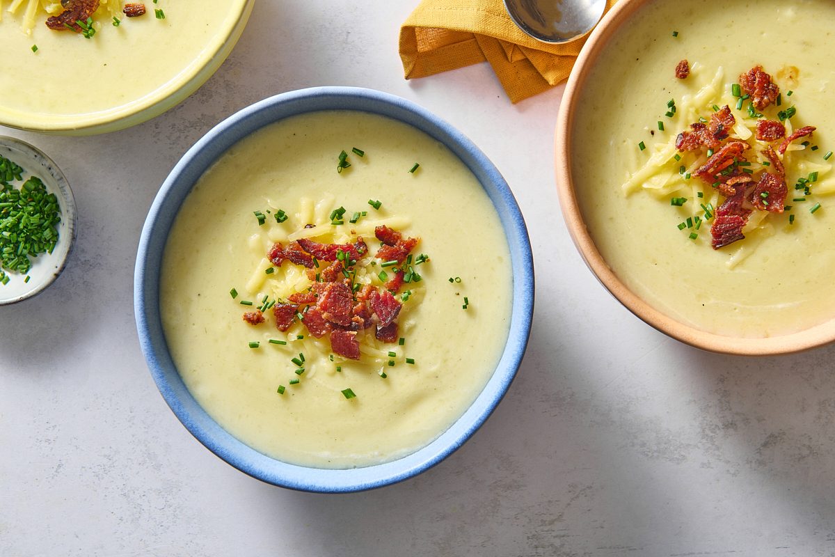 Overhead shot of three bowls of slow cooker potato soup