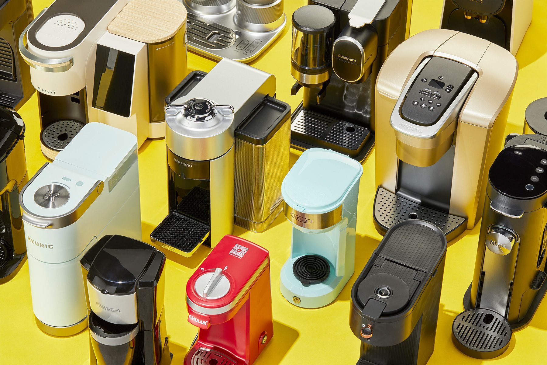 Group Shot of Multiple Coffee Makers Over Yellow Background