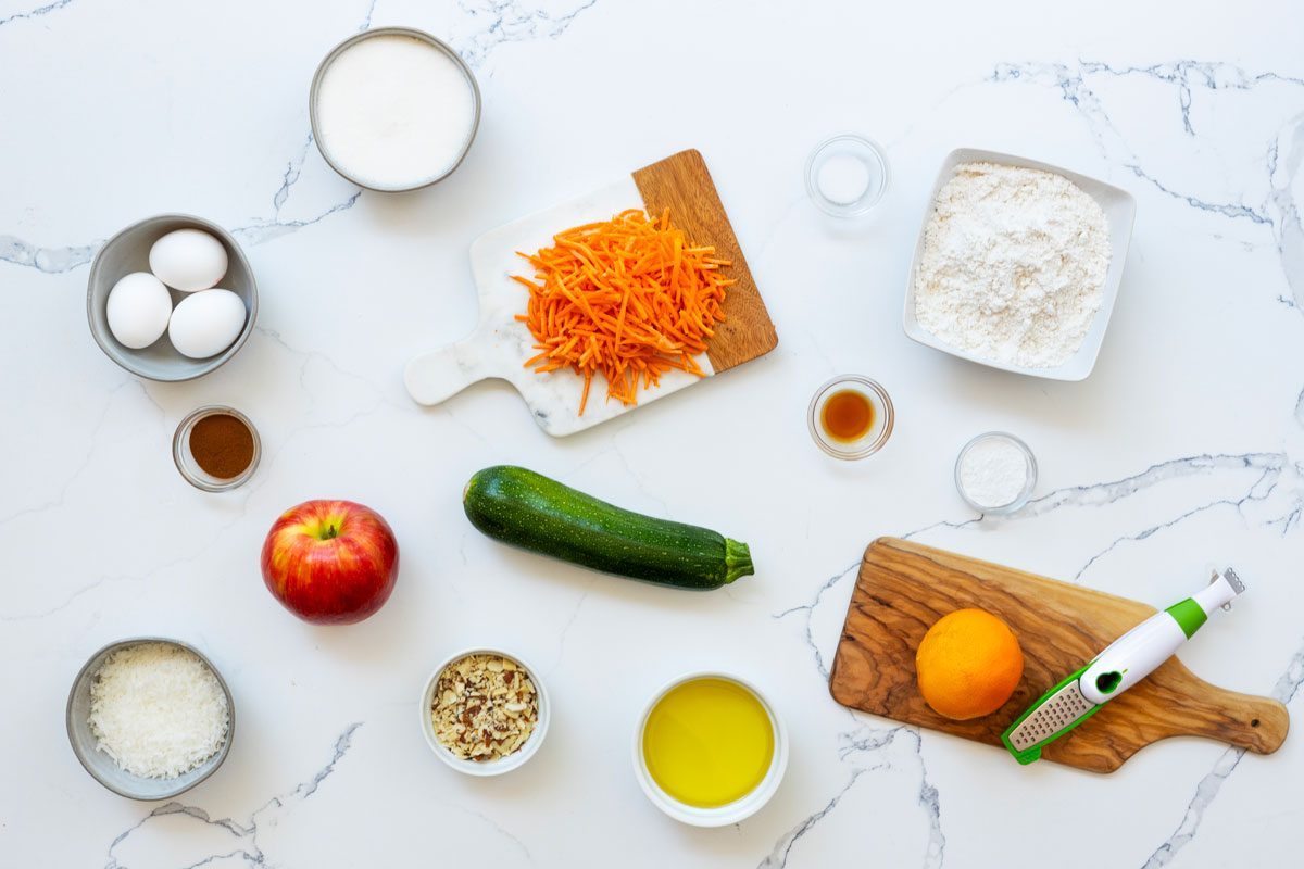 Zucchini Carrot Muffins ingredients on a marble kitchen countertop