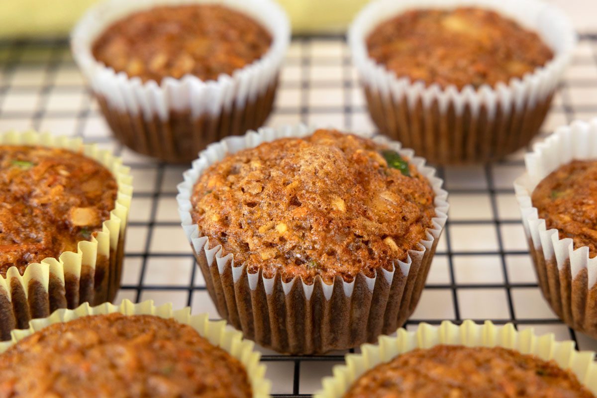 zucchini carrot muffins on a cooling rack