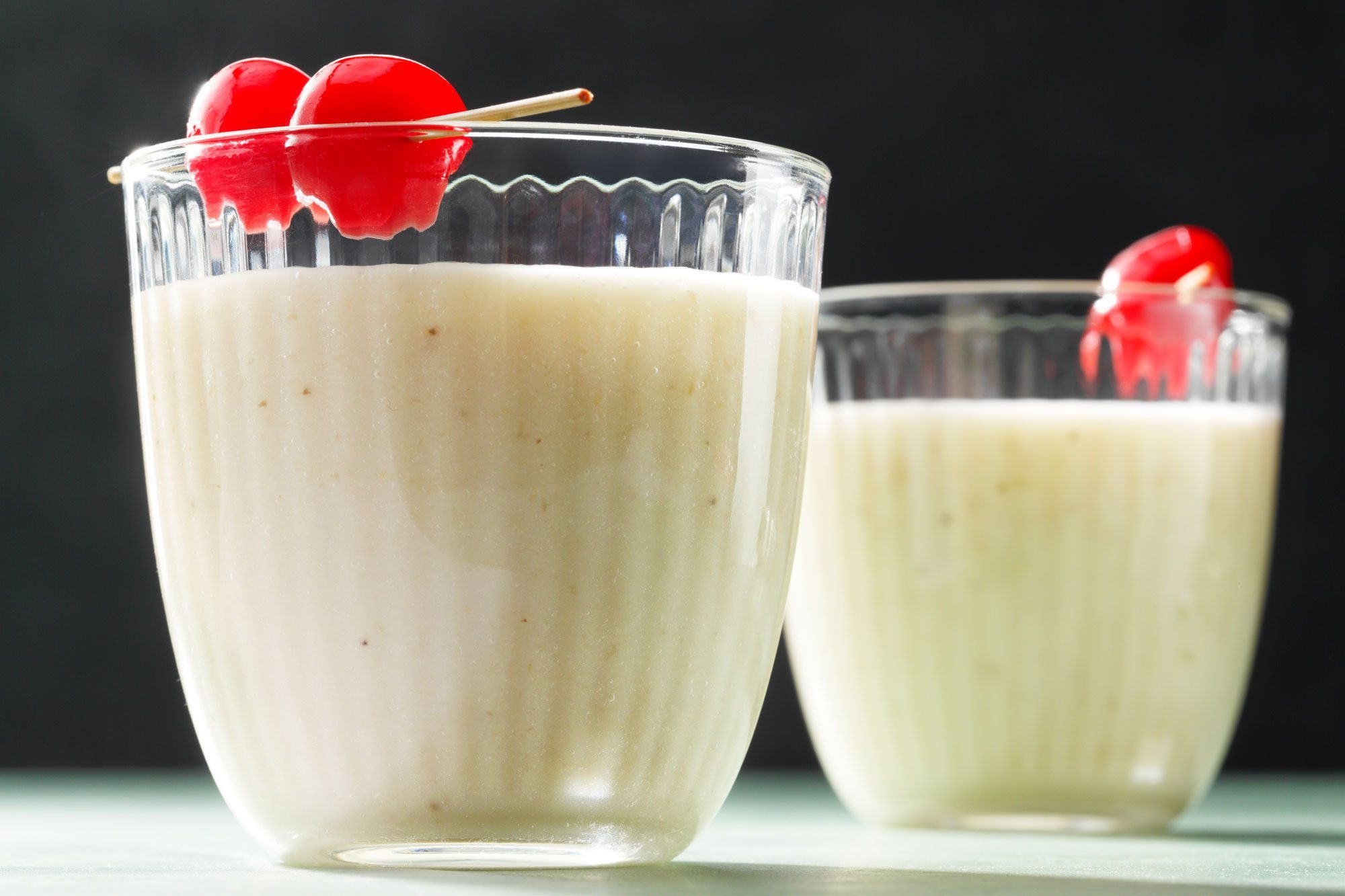 Banana Daiquiri served in chilled glasses garnished with cherry