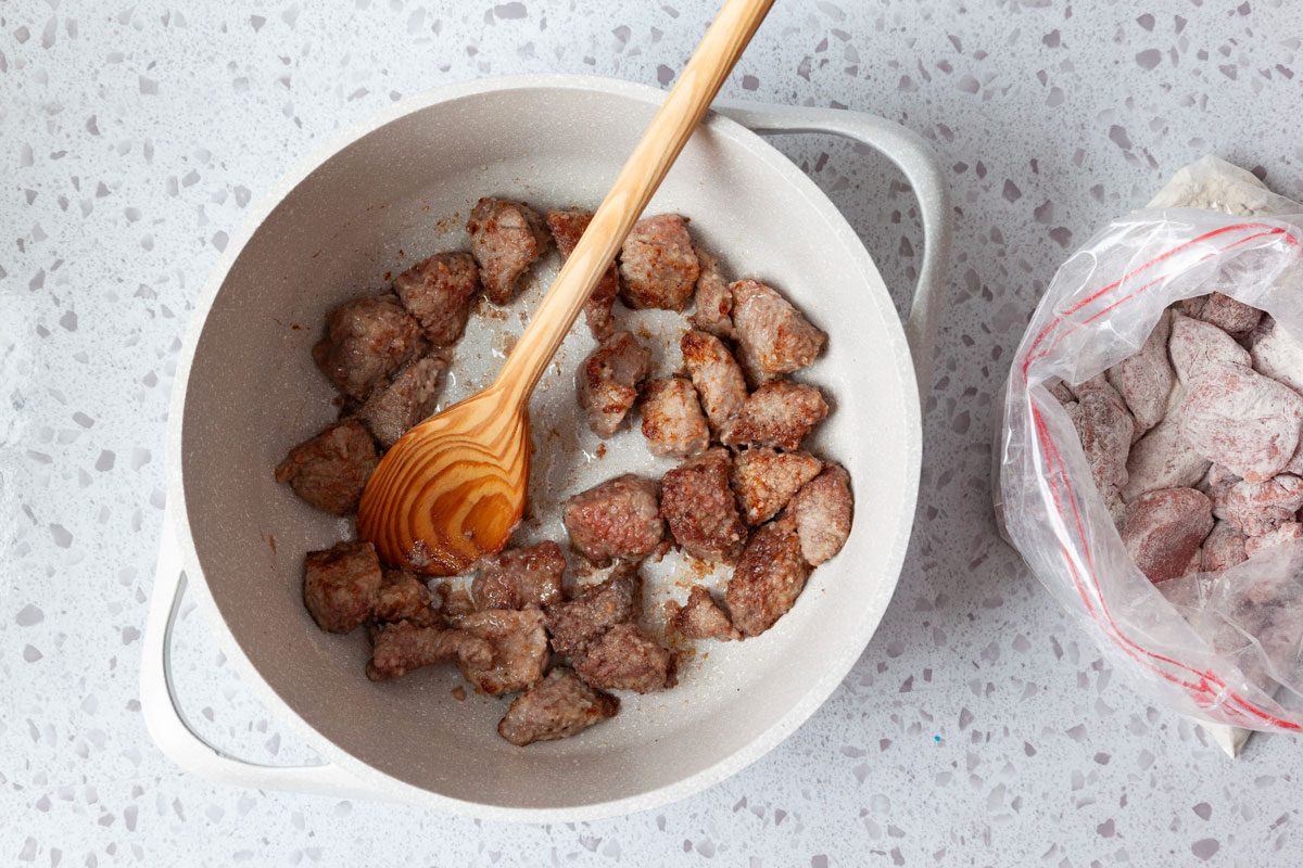 Step 1 of Taste of Home Beef Stew with Dumplings is to toss the meat with flour, salt and pepper before cooking in a pan in oil