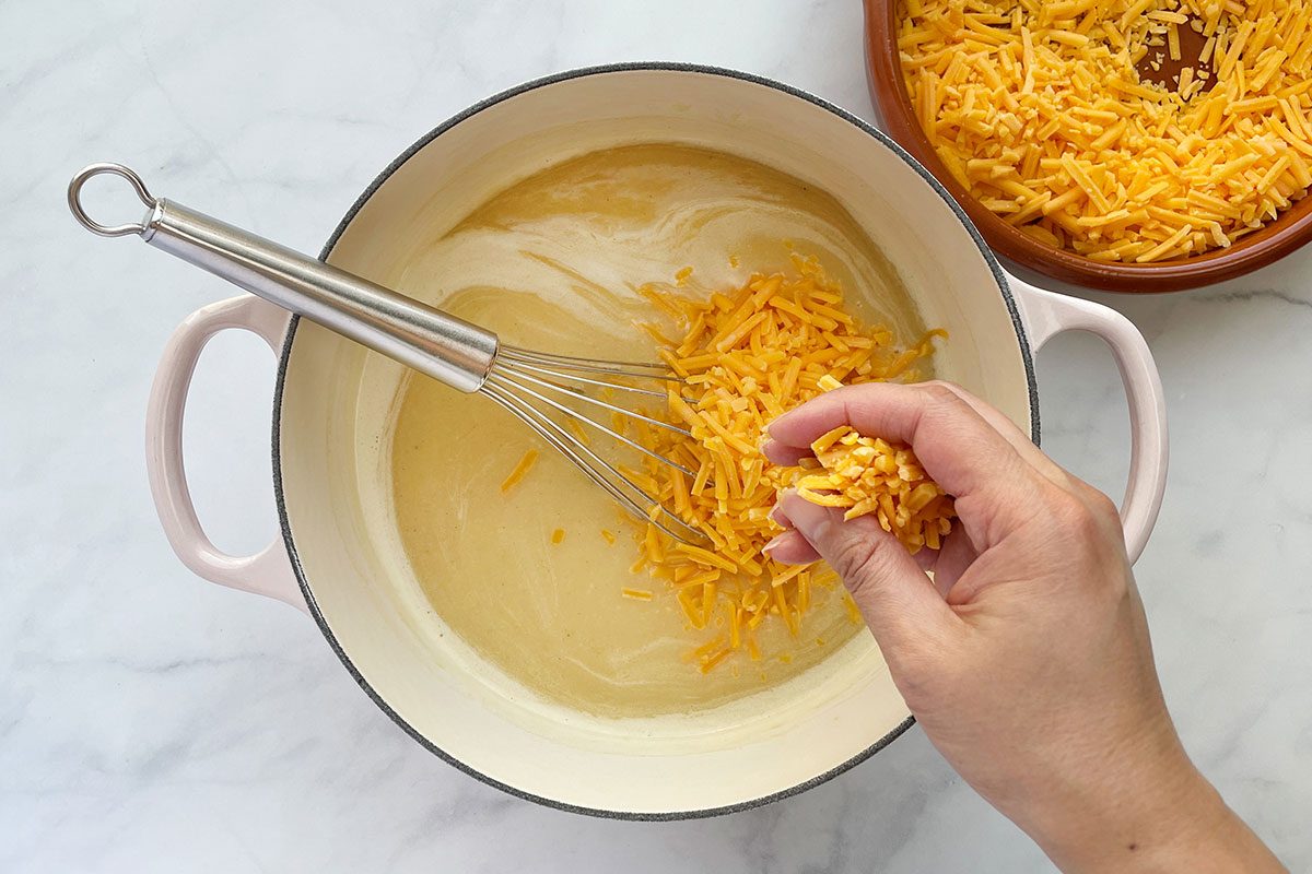 Step 3 for how to make Taste of Home's Beer Cheese Soup recipe; adding shredded cheese