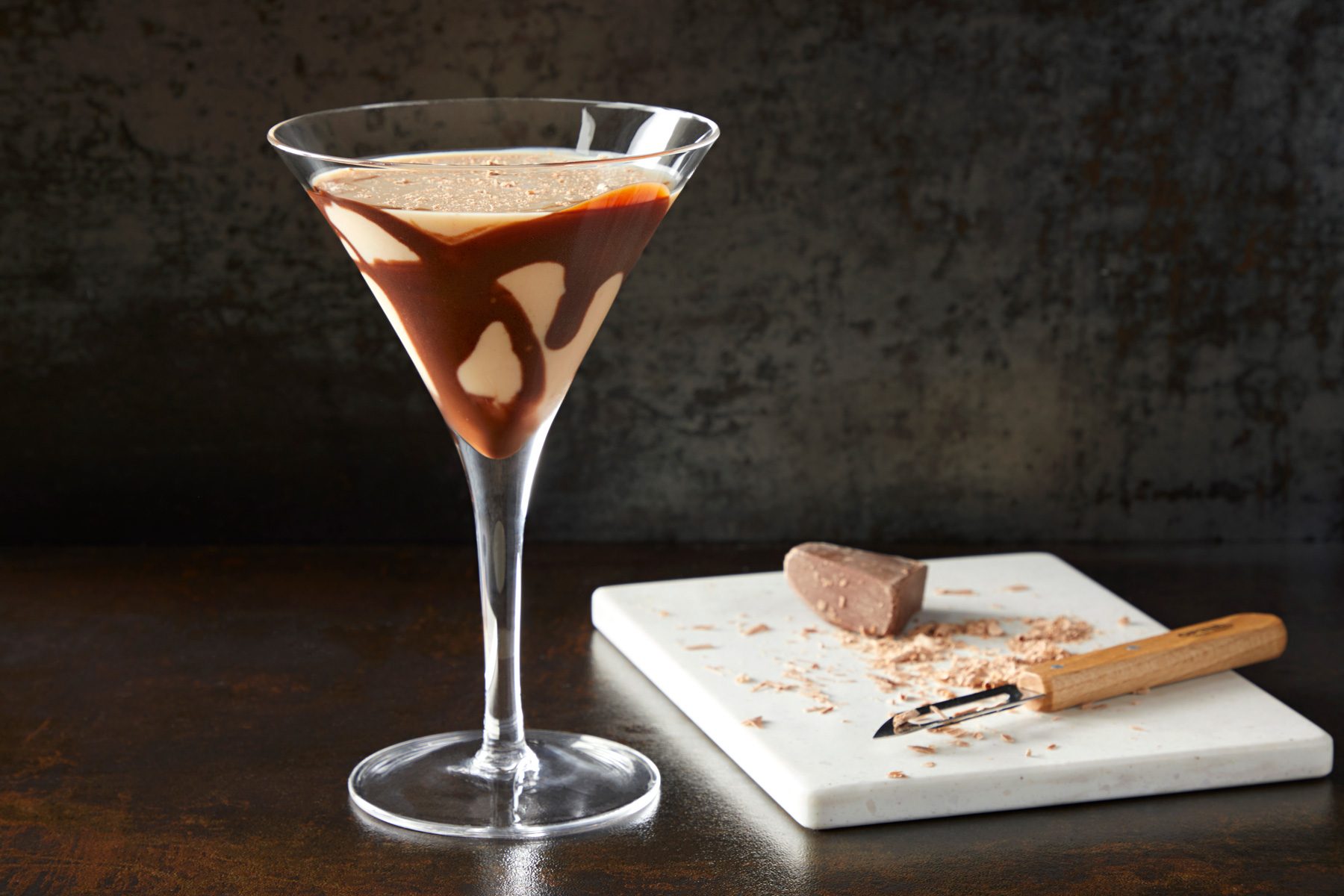 Chocolate Martini on a table with chocolate shavings in the back