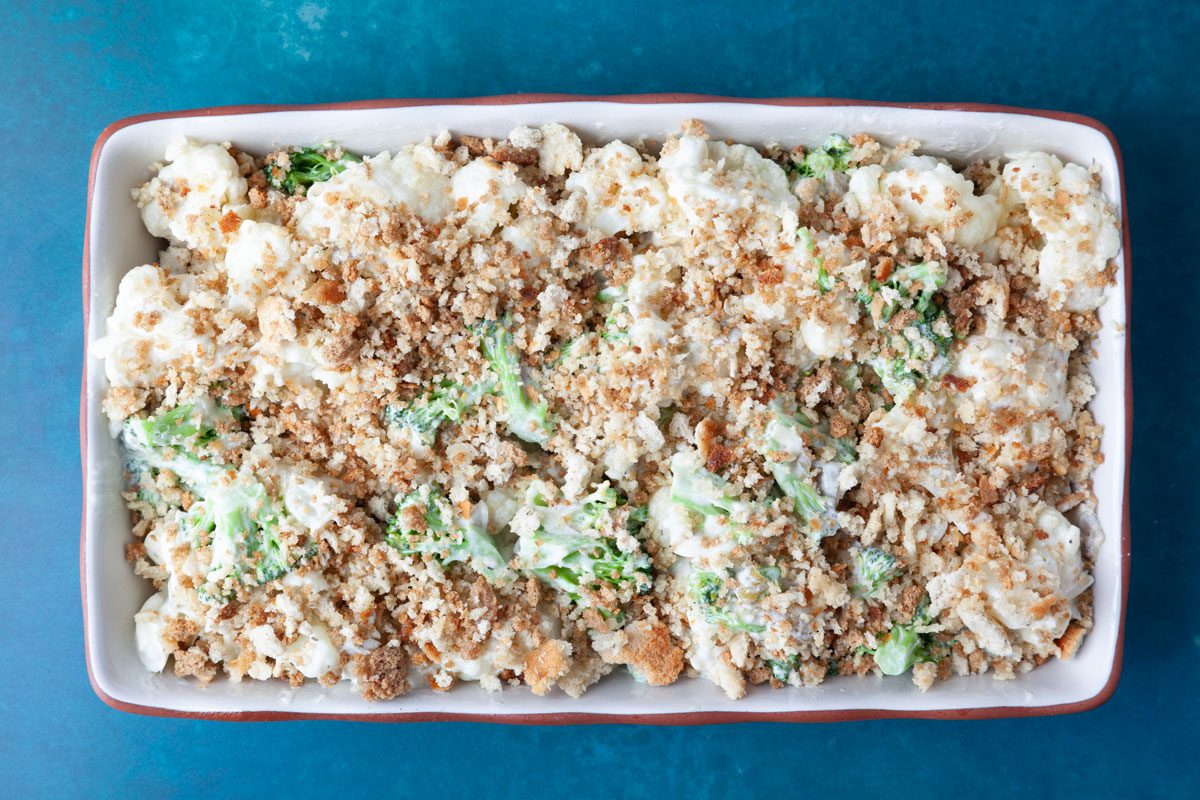 Step 3 of Taste of Home Broccoli Cauliflower Bake is to add the mixture to a baking pan and top with the remaining butter mixed with stuffing mixture