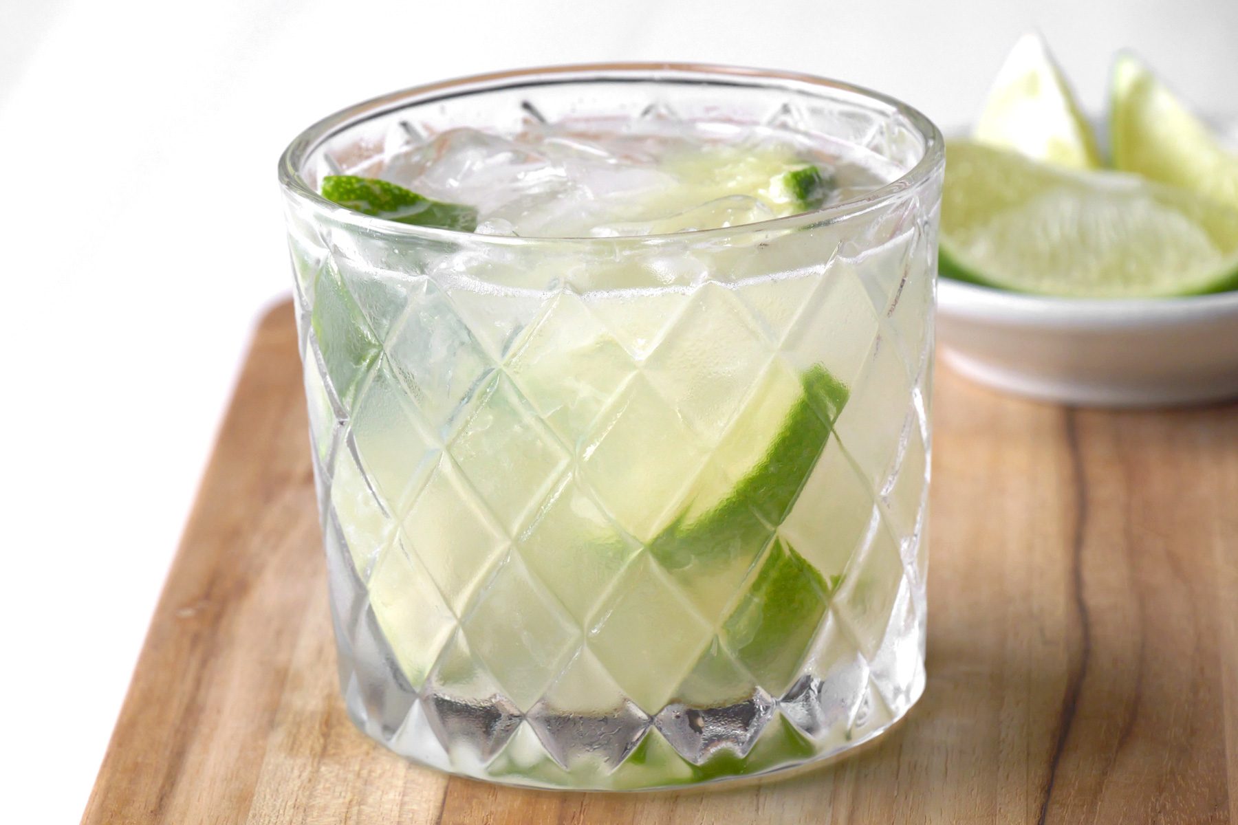 Close up of a glass of Caipirinha drink on a wooden tray