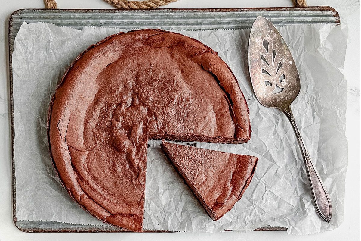 Taste Of Home Chocolate Cheesecake On A White Plate With Strawberries