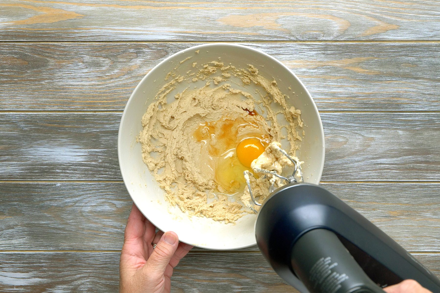 overhead shot of Beating eggs and vanilla in a bowl