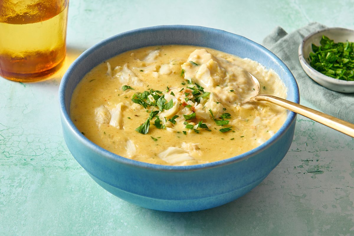 Closeup of cream of crab soup in a bowl with a spoon