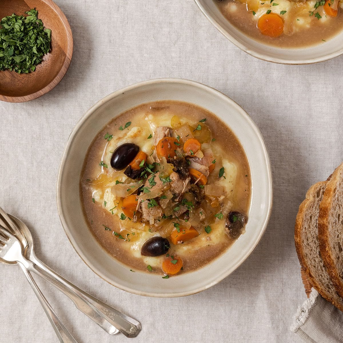 Pork stew served in bowls with mashed potato.