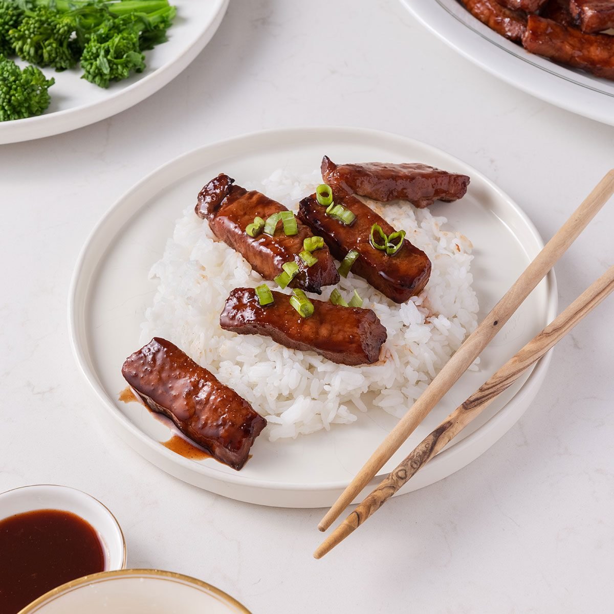 Chinese Boneless Spare Ribs photographed for Taste of Home. Ribs on a plate with rice and chopsticks.