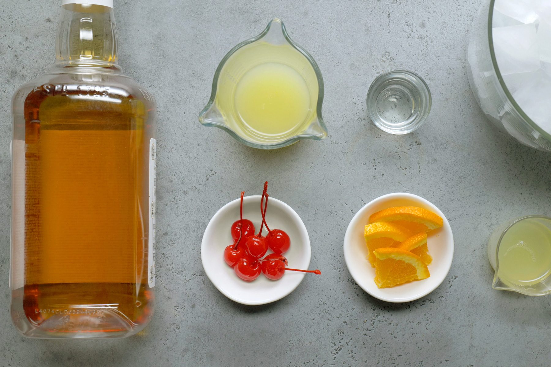 Ingredients for Whiskey Sour cocktail arranged on a table