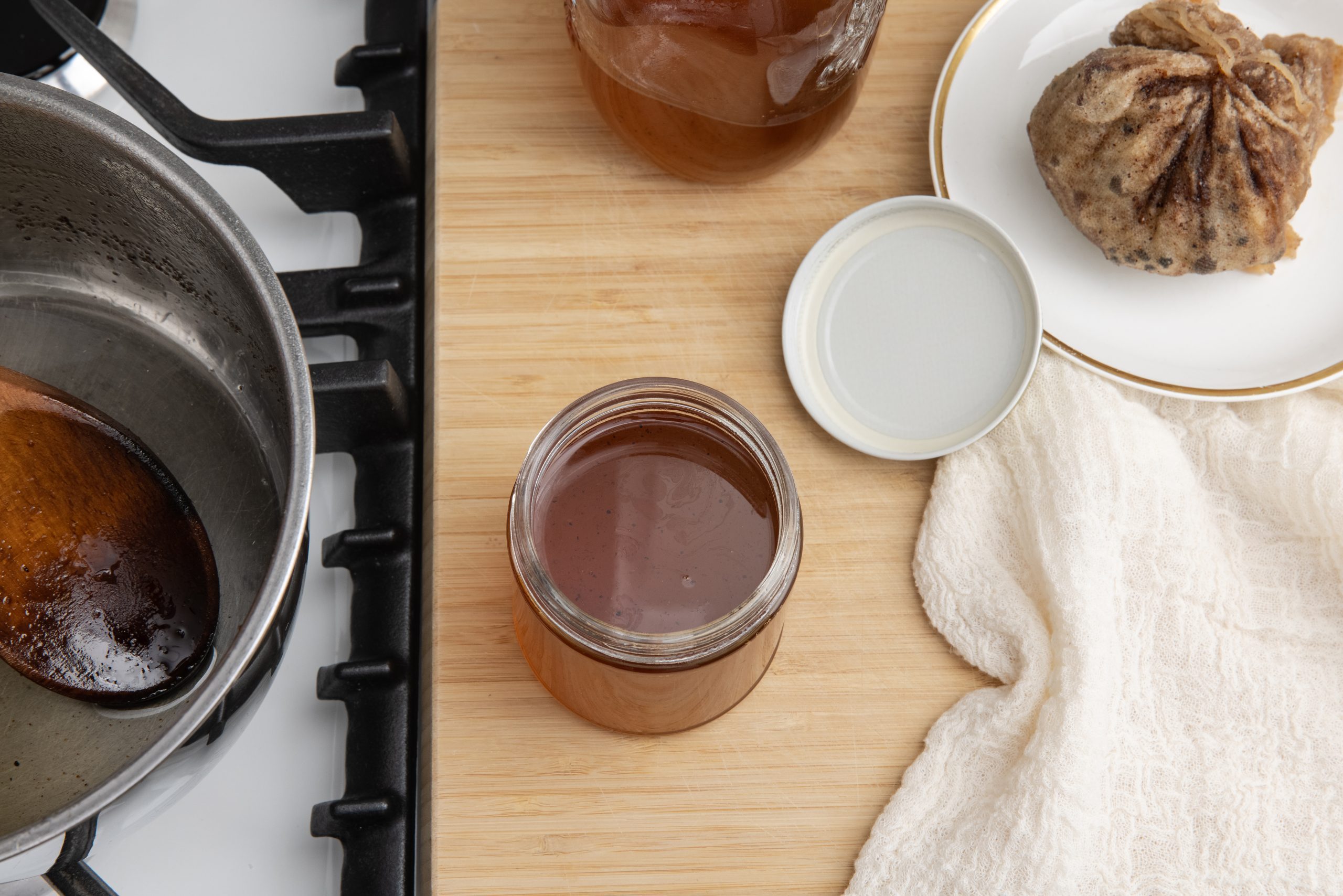 Gingerbread syrup being added to air tight containers after cooling down.