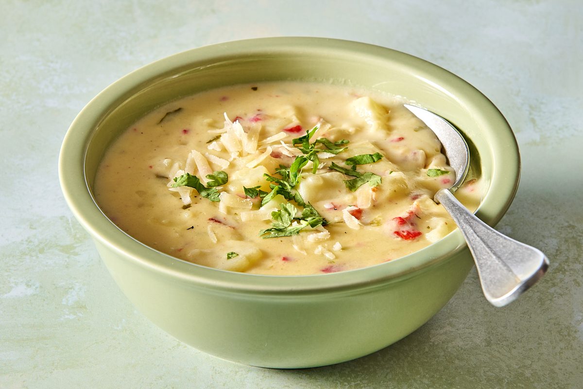 Closeup of a bowl of Instant Pot potato soup with a spoon in it