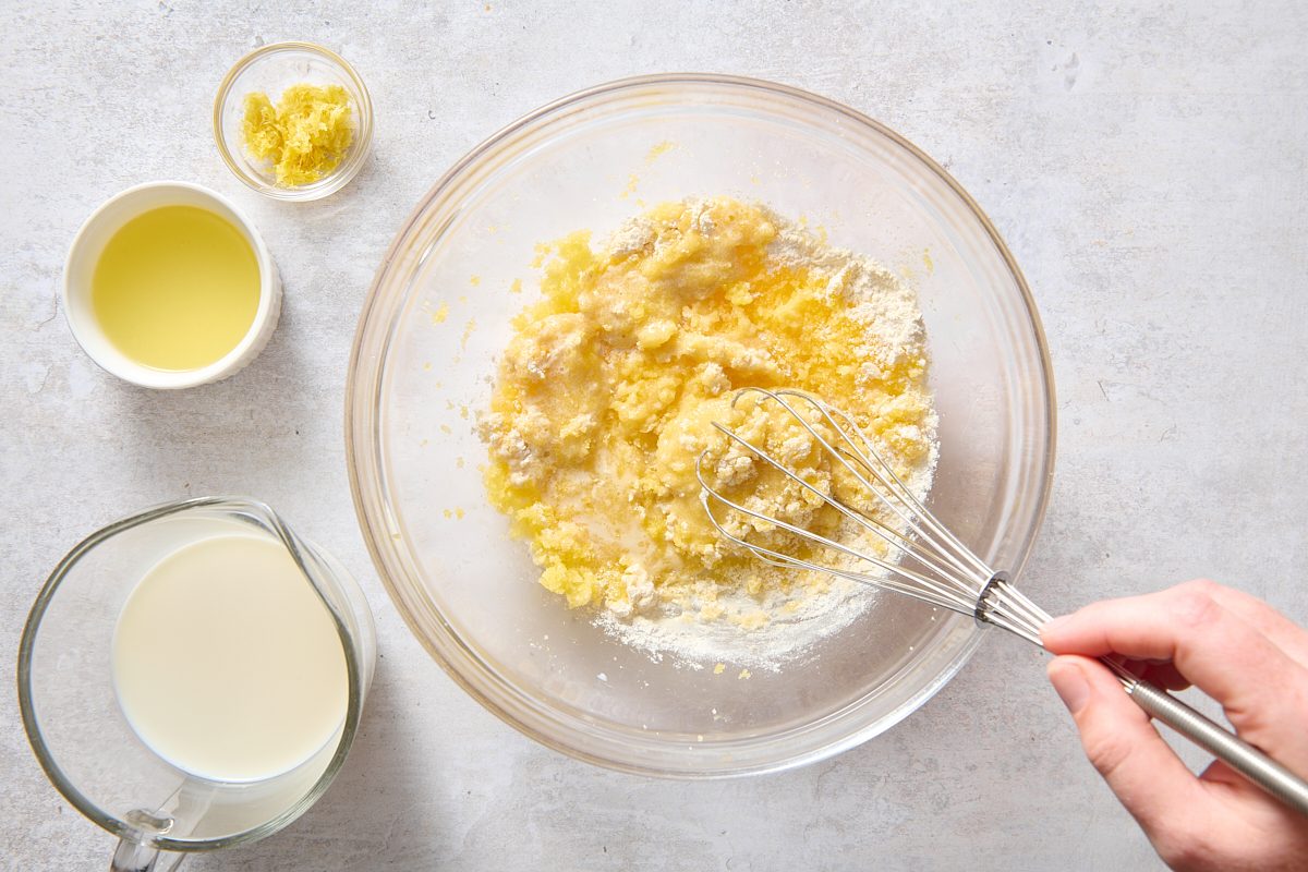 Whisking lemon custard ingredients in a bowl