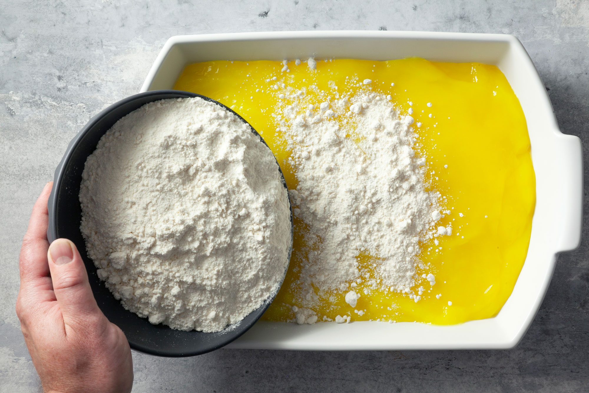 Sprinkle one bowl of the cake mix into the dish