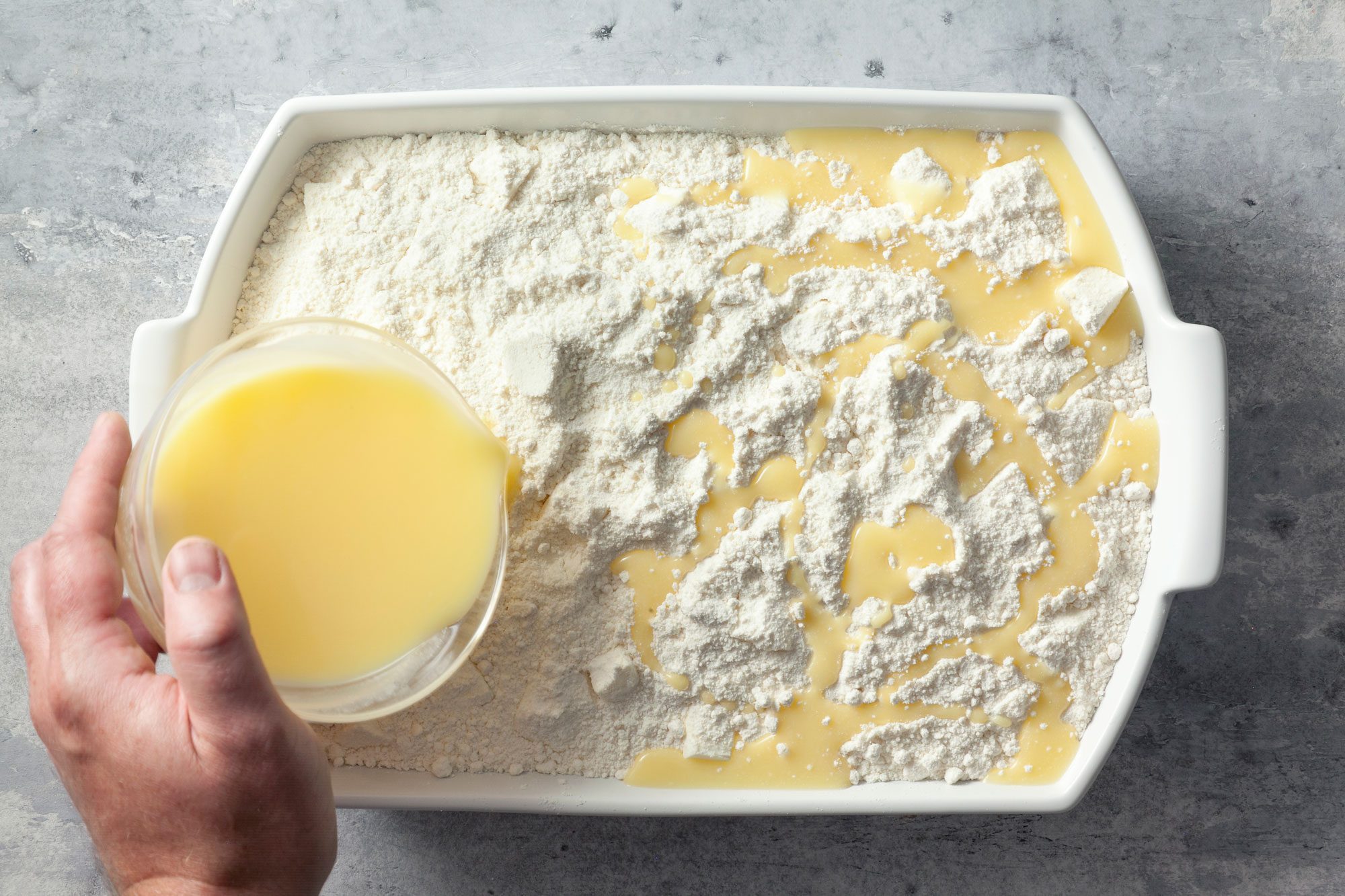 Pour melted butter over the cake mix