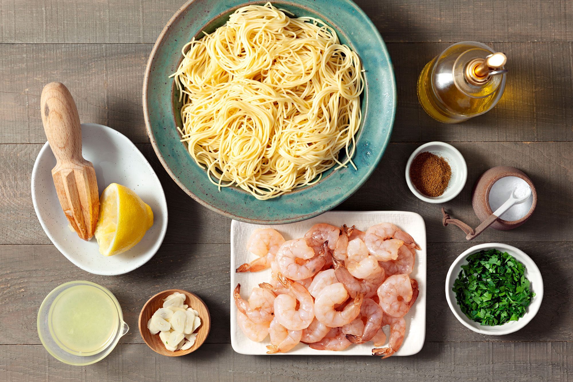 Overhead shot of all ingredients for Lemon Garlic Shrimp; wooden background;