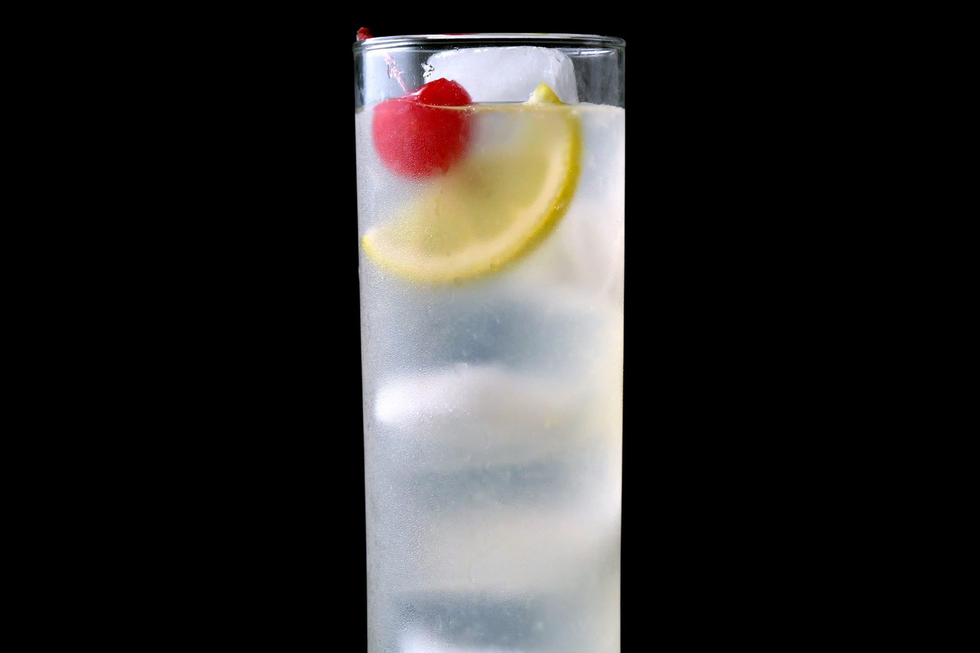 Lemon Tom Collins garnished with lemon slice and cherry