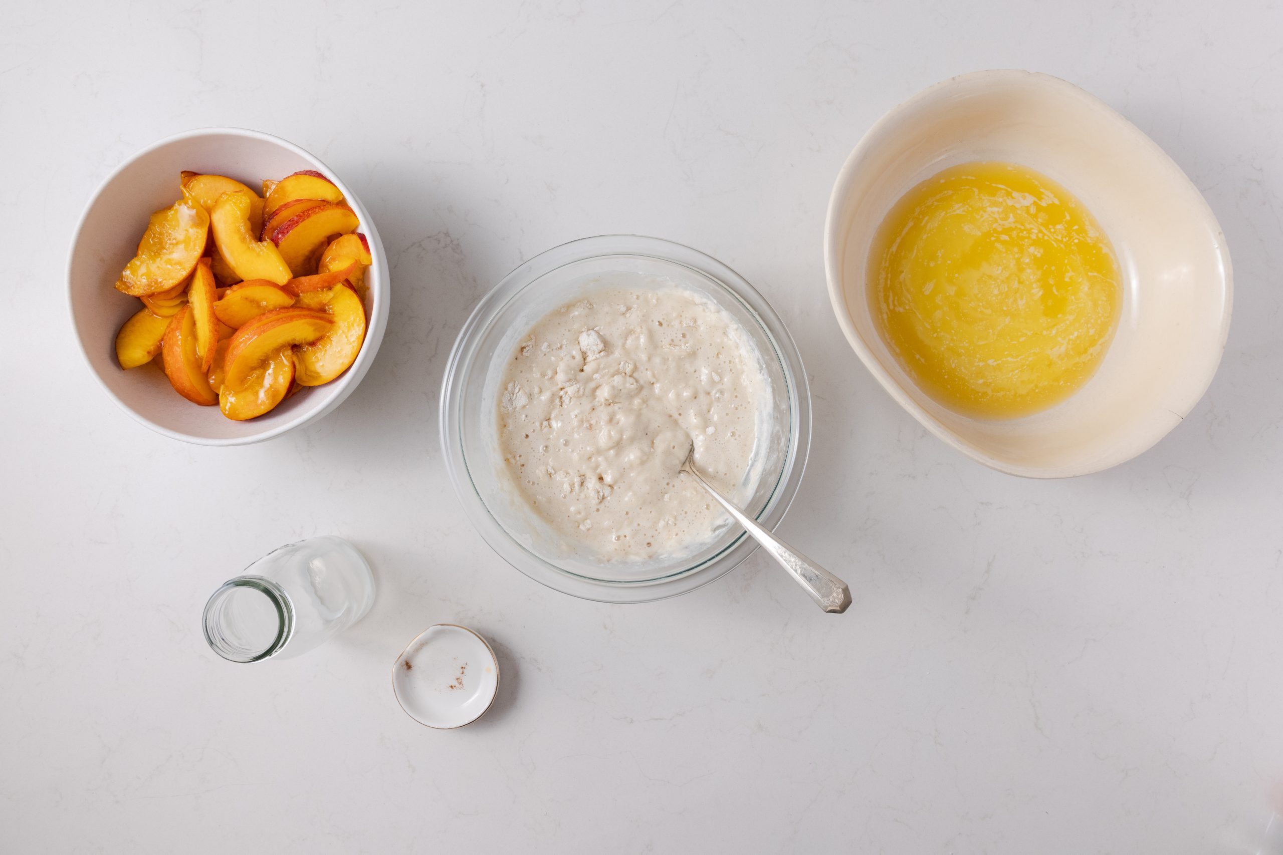 Mixing ingredients and preparing baking dish with melted butter. 