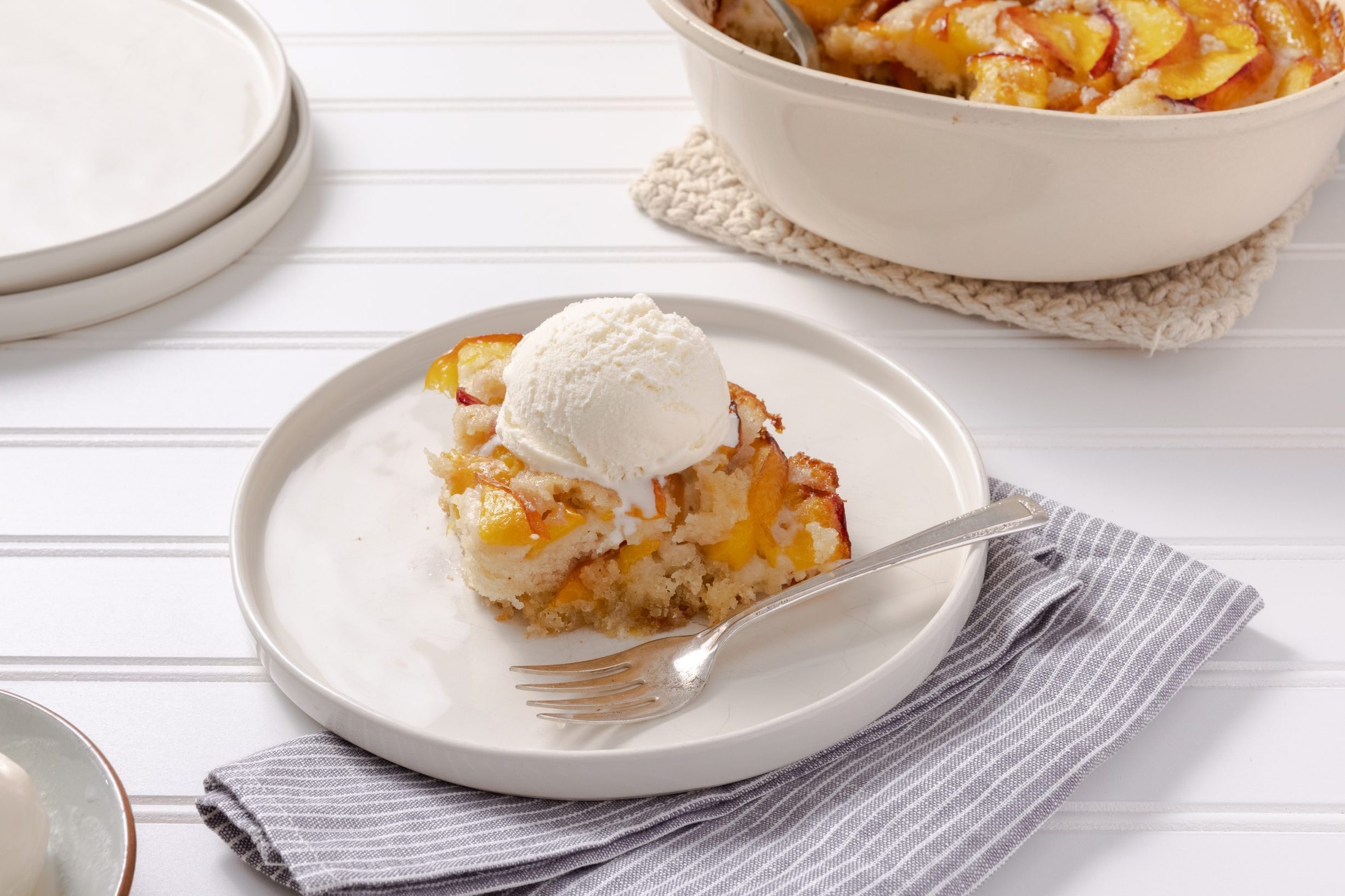 Nectarine Cobbler served with ice cream on a plate. 