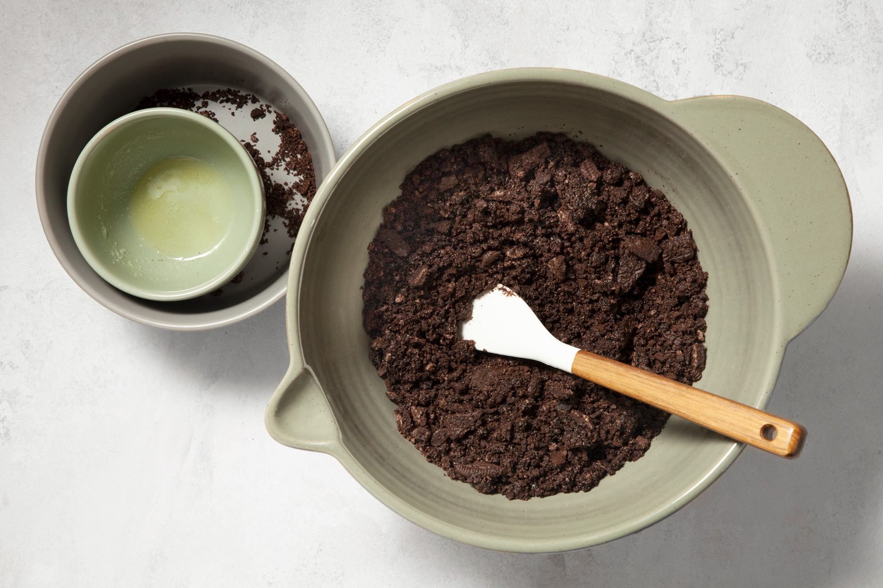 Cookie crumbs and butter mixed in a big bowl